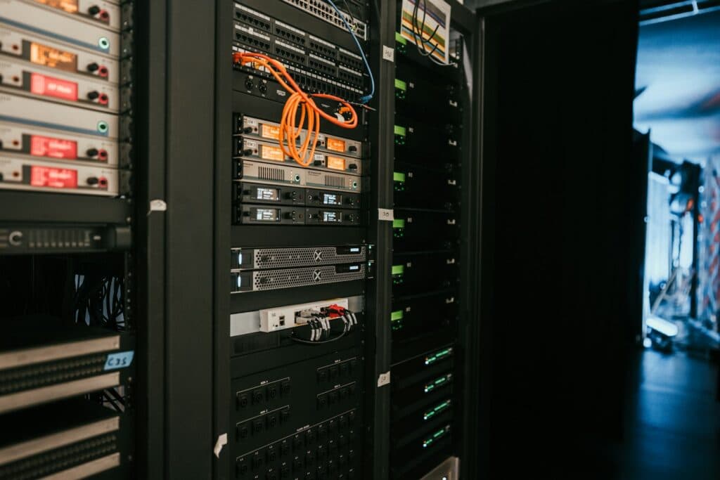 Server racks and network cables representing website hosting and recovery infrastructure.